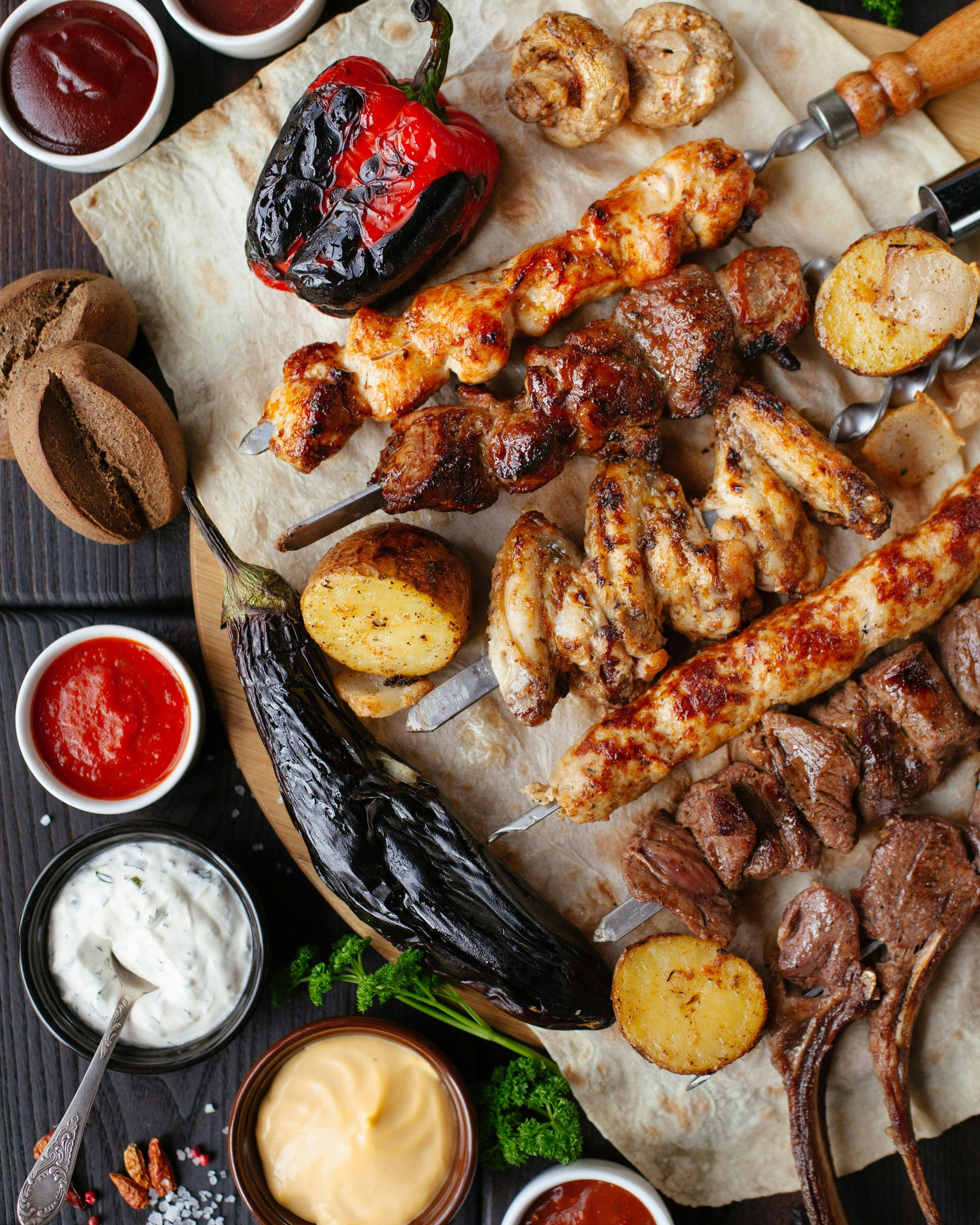 Platter of variety of grilled meat, vegetable and dipping sauces
