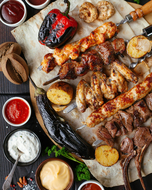 Platter of variety of grilled meat, vegetable and dipping sauces