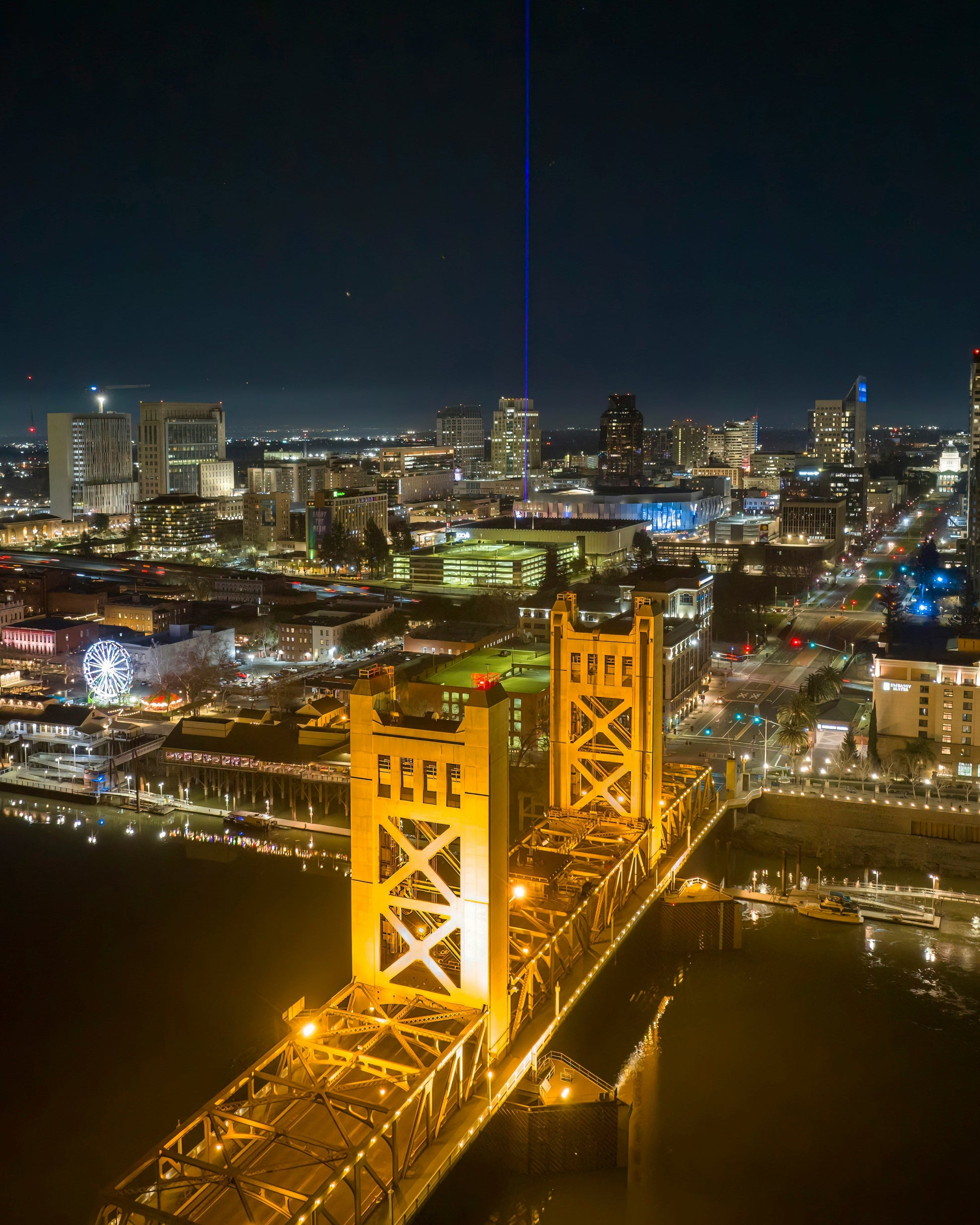 Cityscape at night with illuminated bridge and buildings